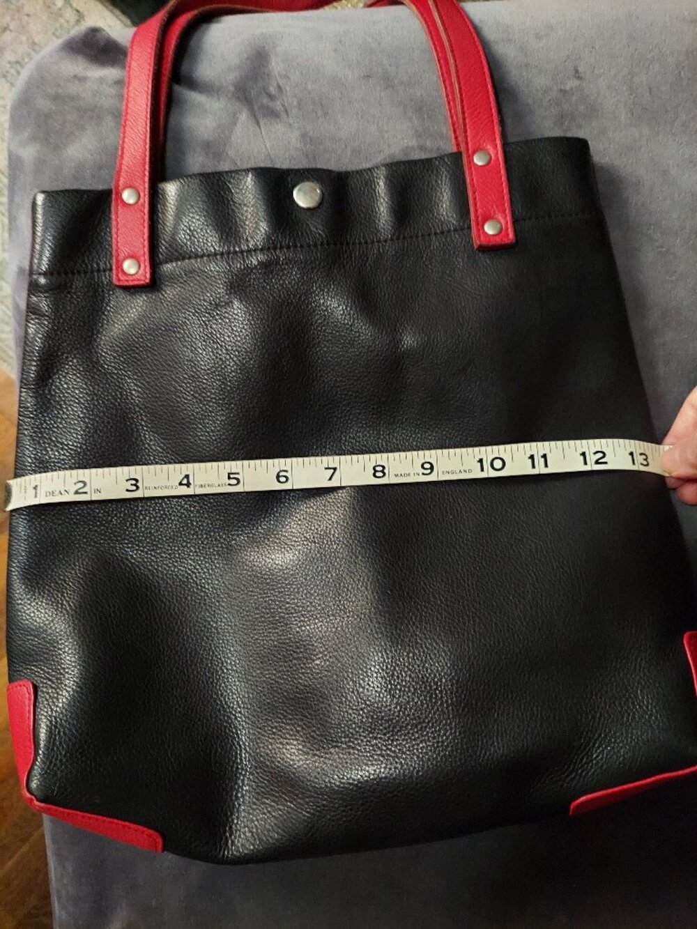 Black leather shoulder bag w/ red leather trim by Designer Guild